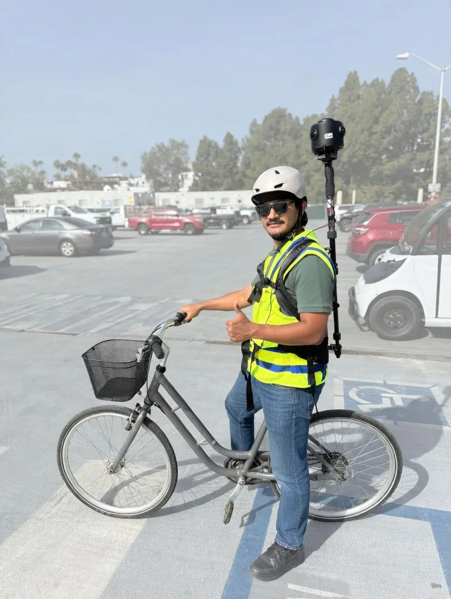 GeoCam operator with a backpack-mounted 360 camera and e-bike ready to capture a campus
